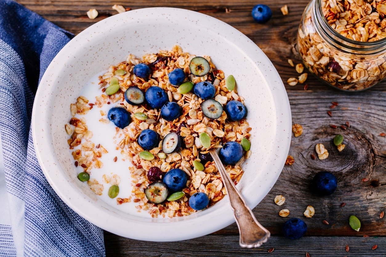 A typical healthy breakfast containing starch: oat granola with yogurt, fresh blueberries and pumpkin seeds