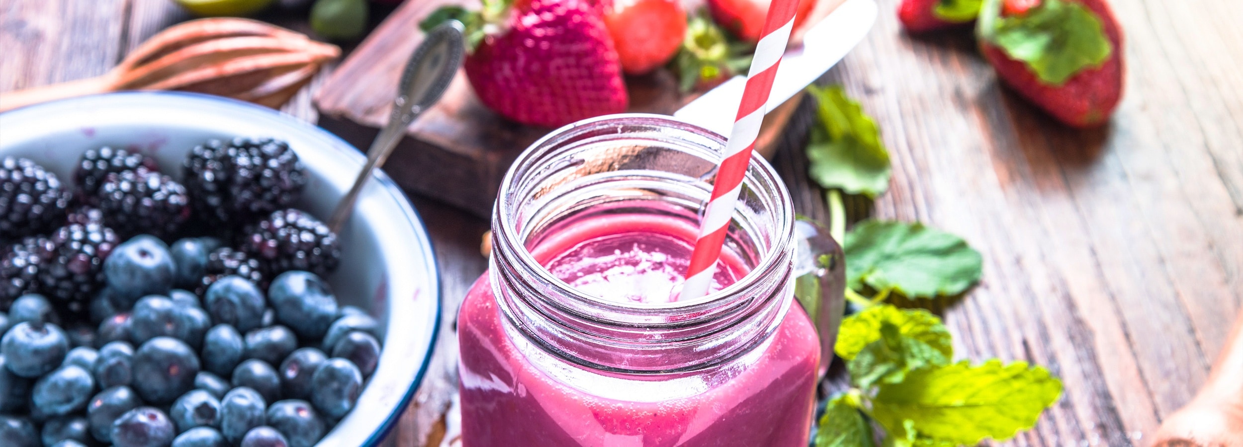 Fruit smoothie with berries and straw